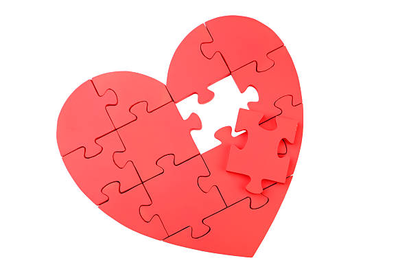 istock Red puzzle heart isolated on white 520409286
