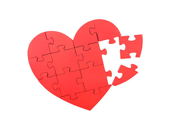 istock Red puzzle heart isolated on white 520409304