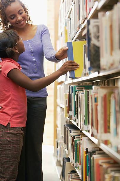 Librarian and young girl choosing a book
