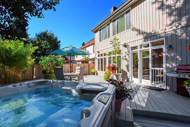 Backyard with hot tub and patio area stock photo