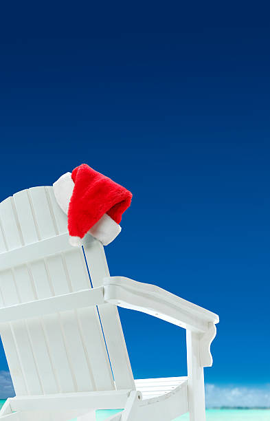 istock Santa Hat On A Beach Chair In Tropical Setting 520410635