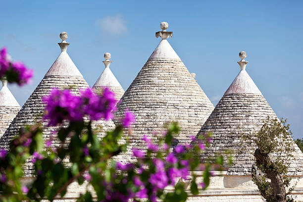 Trullo in Puglia Italy A limestone trullo in Puglia, in the Itrea Valley, in Southern Italy, the only place that these dry stone buildings with their conical roofs can be found. Mostly built as field or agricultural buildings, many became homes and are now sought after for refurbishment and holiday homes. trulli house photos stock pictures, royalty-free photos & images