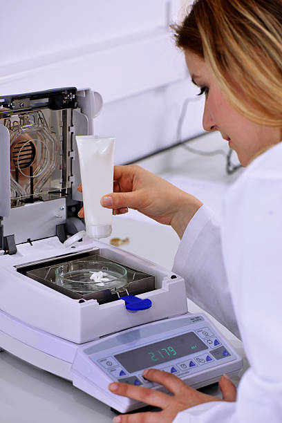 istock Testing machine and young woman at the laboratory 520410791