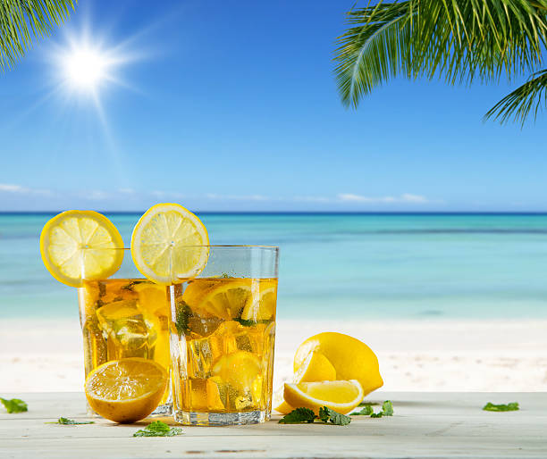 istock Glasses of summer ice tea drink on beach 520411480