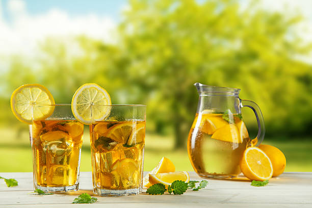 istock Cups of ice tea with trees on background 520411910