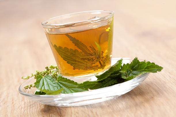 istock herbal tea with stinging nettle on wooden floor 520412031