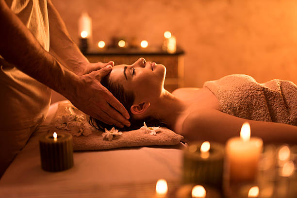 istock Relaxed woman enjoying during head massage at the spa. 520412908