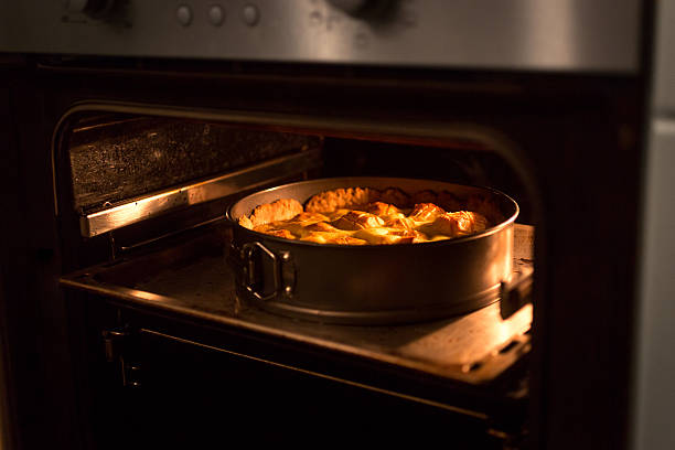 istock Closeup of apple pie baking in oven at kitchen 520412942