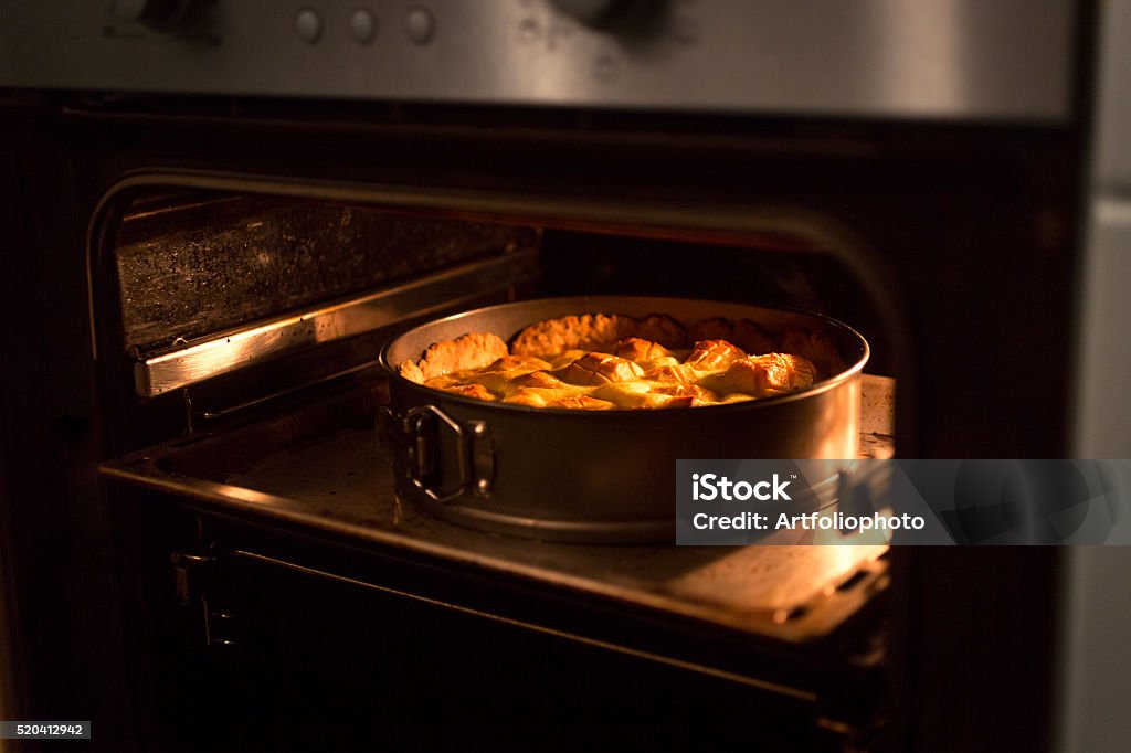Closeup of apple pie baking in oven at kitchen Closeup photo of apple pie baking in oven at kitchen Apple - Fruit Stock Photo