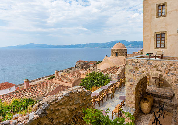 traditional view of stone houses and sights greece monemvasia traditional view of stone houses and sights in main capitol in mani Peloponnese with sea background monemvasia stock pictures, royalty-free photos & images