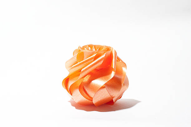 istock orange rose ribbon on white blackground 520414520