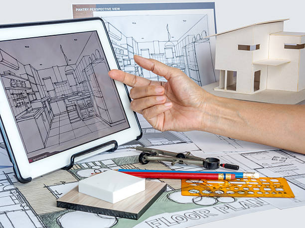 istock Architect working with tablet, house model, blueprints/ housing development business 520415008