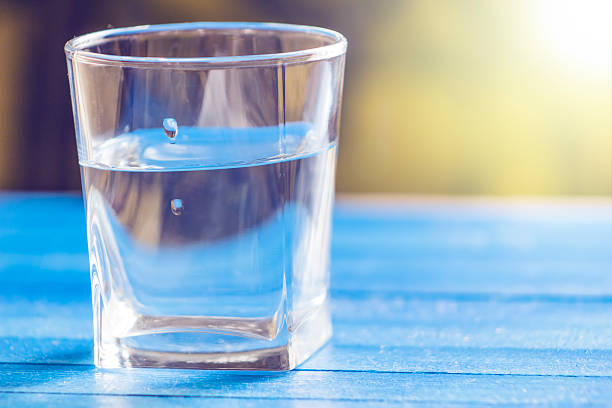 istock Water in  glass, on blue background 520415458