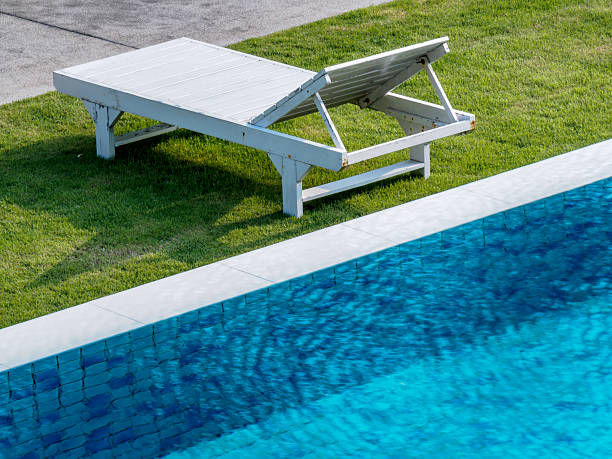 istock Modern swimming pool with sunbed in summer day 520418174