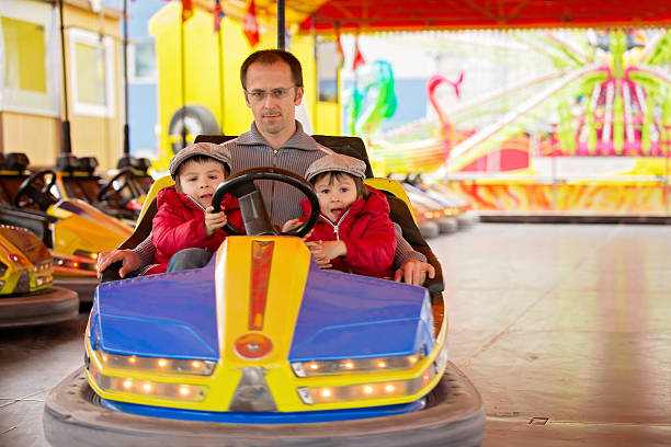 istock Father and his two sons having ride in bumper car 520419726