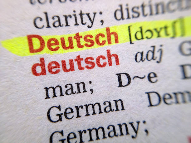 German - Deutsch in dictionary Closeup of the word German, highlighted on a dictionary page. Shot with an iPhone. german language photos stock pictures, royalty-free photos & images