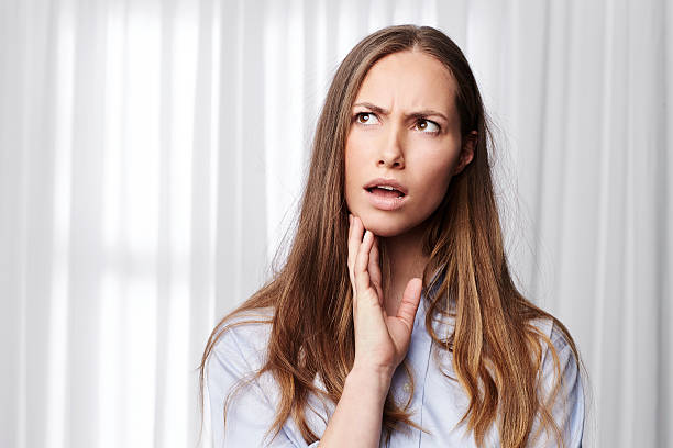 istock Beautiful young woman looking confused 520420618