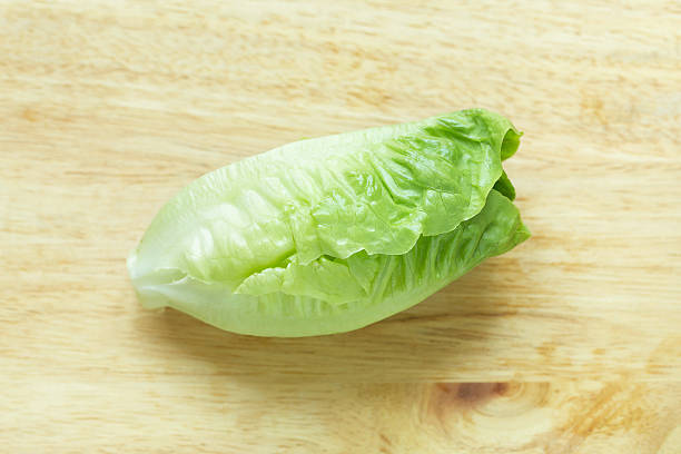 istock Cos Lettuce on wood background 520421002