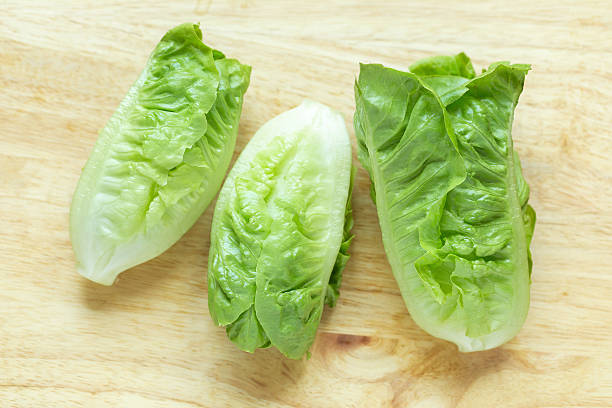 istock Cos Lettuce on wood background 520421458