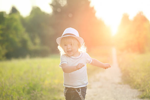 istock Happy little boy running in a park 520421864