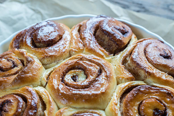 istock Cinnamon rolls on the wooden background 520422014