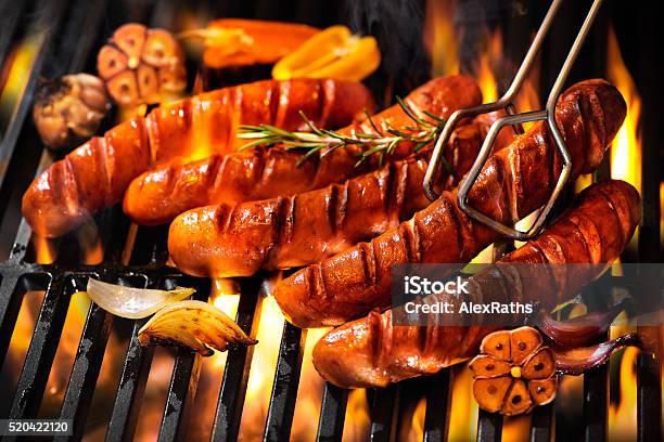 Sausages On The Barbecue Grill With Flames Stock Photo - Download Image Now - Sausage, Barbecue Grill, Barbecue - Meal