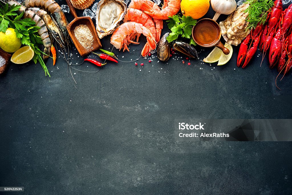 Shellfish plate of crustacean seafood Shellfish plate of crustacean seafood with shrimps, mussels, oysters as an ocean gourmet dinner background Oyster Stock Photo
