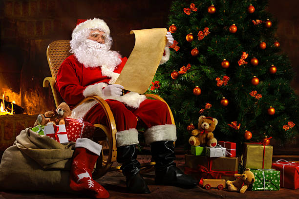 istock Santa Claus sitting in front of fireplace 520423082