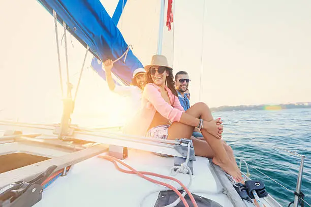 Photo of Friends having fun on sailboat.