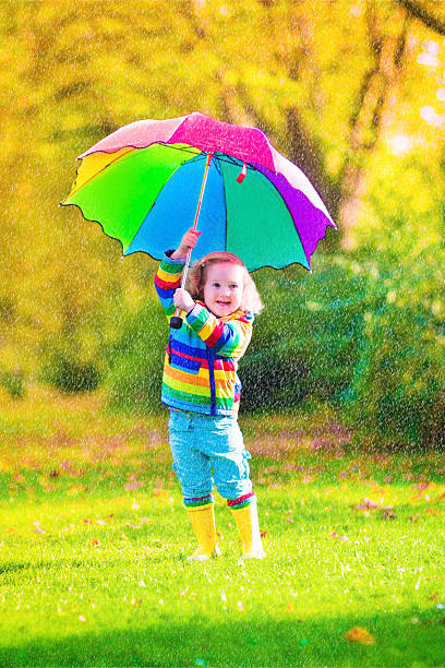 istock Little cute girl with umbrella 520436373
