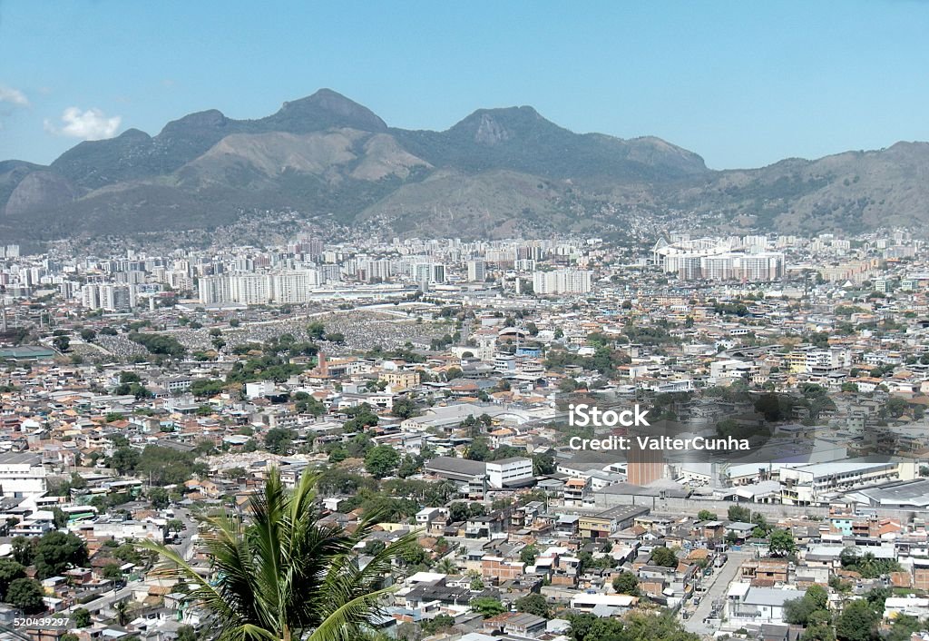 Panoramic view of the North Zone of Rio de Janeiro Panoramic view of the neighborhoods of the North Zone of Rio de Janeiro, brazil, with emphasis on the Irajá Cemetery and the mountains of Alto da Boa Vista, covered by the vegetation of the Atlantic Forest. Blue Stock Photo