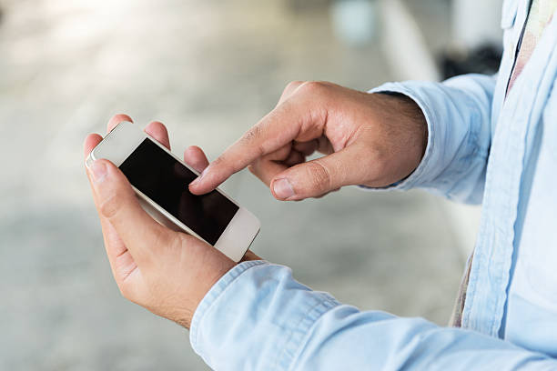 istock Young man using smartphone of street 520440031