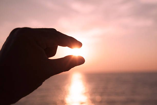 istock Hand and light of the sun. 520440237