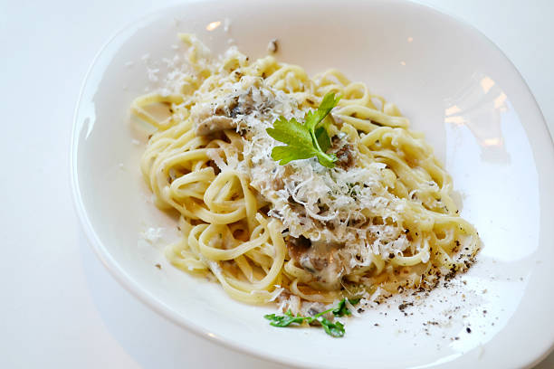 istock Big plate with pasta spaghetti with mushrooms and artichokes 520440443