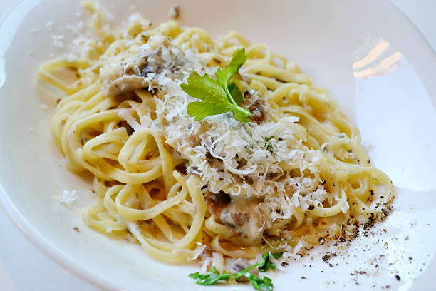 istock Big plate with pasta spaghetti with mushrooms and artichokes 520440445