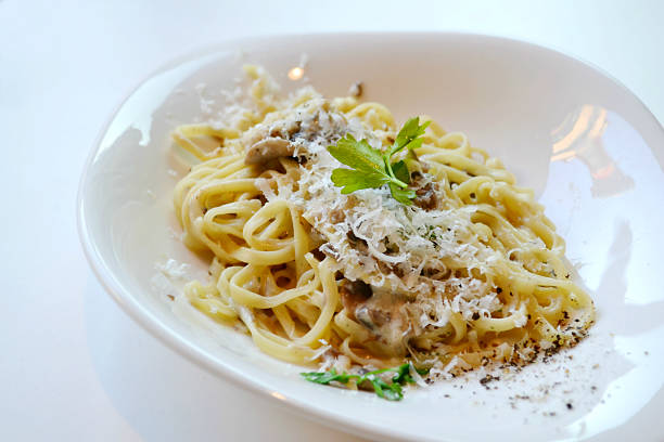 istock Big plate with pasta spaghetti with mushrooms and artichokes 520440447