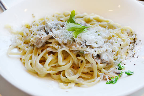 istock Big plate with pasta spaghetti with mushrooms and artichokes 520440449