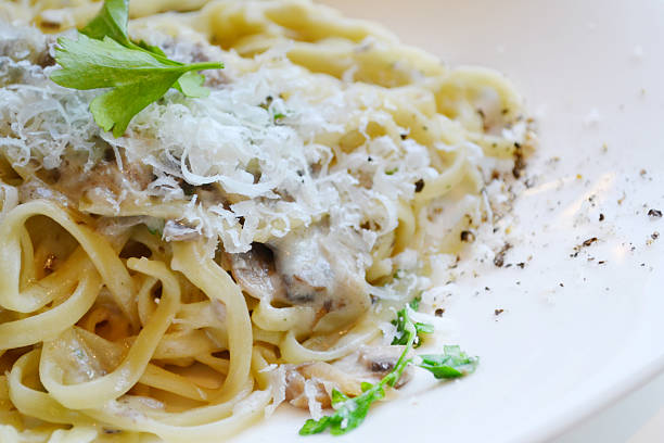 istock Big plate with pasta spaghetti with mushrooms and artichokes 520440457
