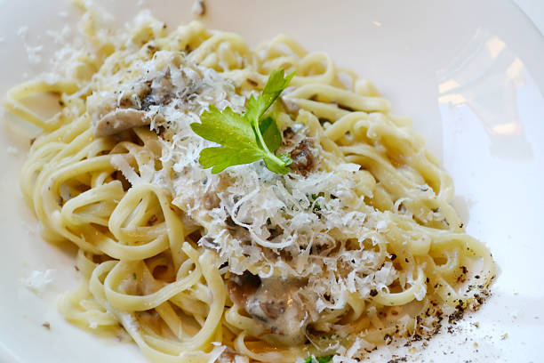 istock Big plate with pasta spaghetti with mushrooms and artichokes 520440459