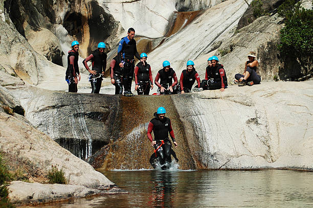 Canyonig in Purcaraccia canyon, Corsica Purcaraccia, France - September 12, 2010: Extreme sports team participates in a canyoning contest on the famous waterfalls of Purcaraccia valley canyoneering stock pictures, royalty-free photos & images