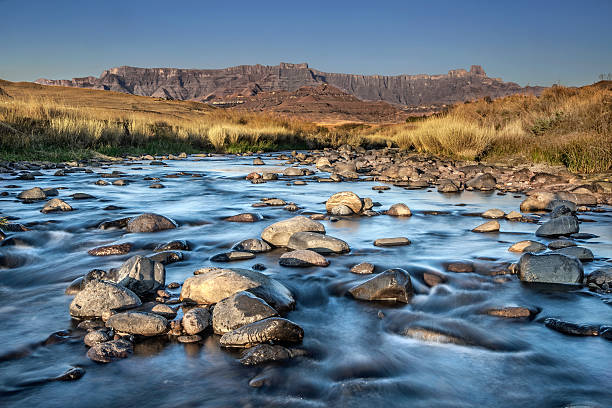 River in front of the Drakensburg River in front of the Drakensburg drakensberg mountain range stock pictures, royalty-free photos & images