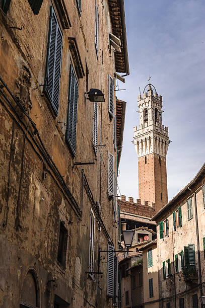 Bell Tower framed by ancient houses stock photo