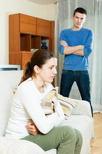 istock Unhappy  woman against standing man 520466135