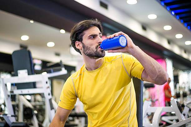 istock Man in the gym hydrating and resting 520466361