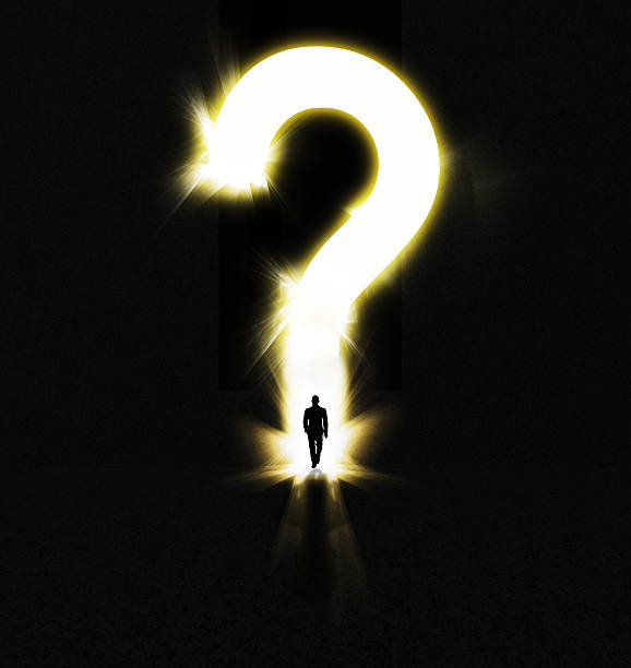 The burning question... Shot of a man walking out of the darkness into a large glowing question mark question mark people one person silhouette stock pictures, royalty-free photos & images
