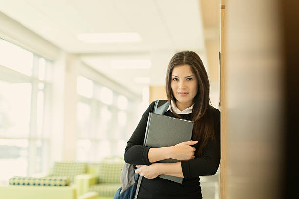 istock Female Hispanic College Student in Library 520469031