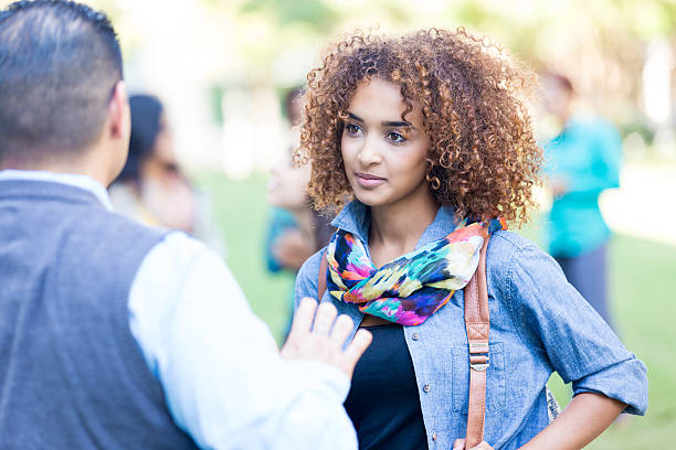 istock Beautiful college student talking to professor outdoors after class 520470191