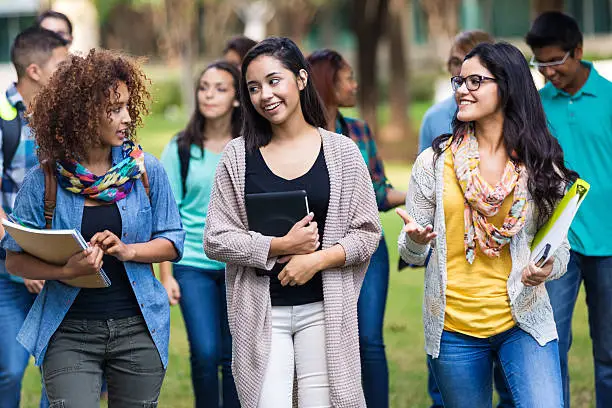 Photo of Popular college or high school girls walking to class together