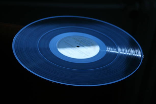 istock Vinyl record - LP dark blue black backround close up 520471225