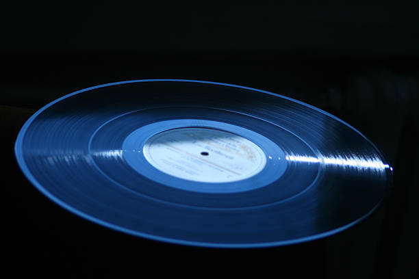 istock Vinyl record - LP dark blue black backround close up 520471227